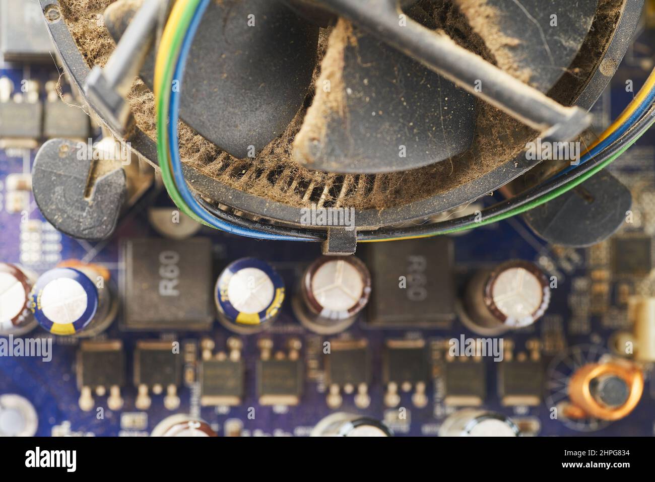 Old computer system unit with spider web and dust inside. Stock Photo