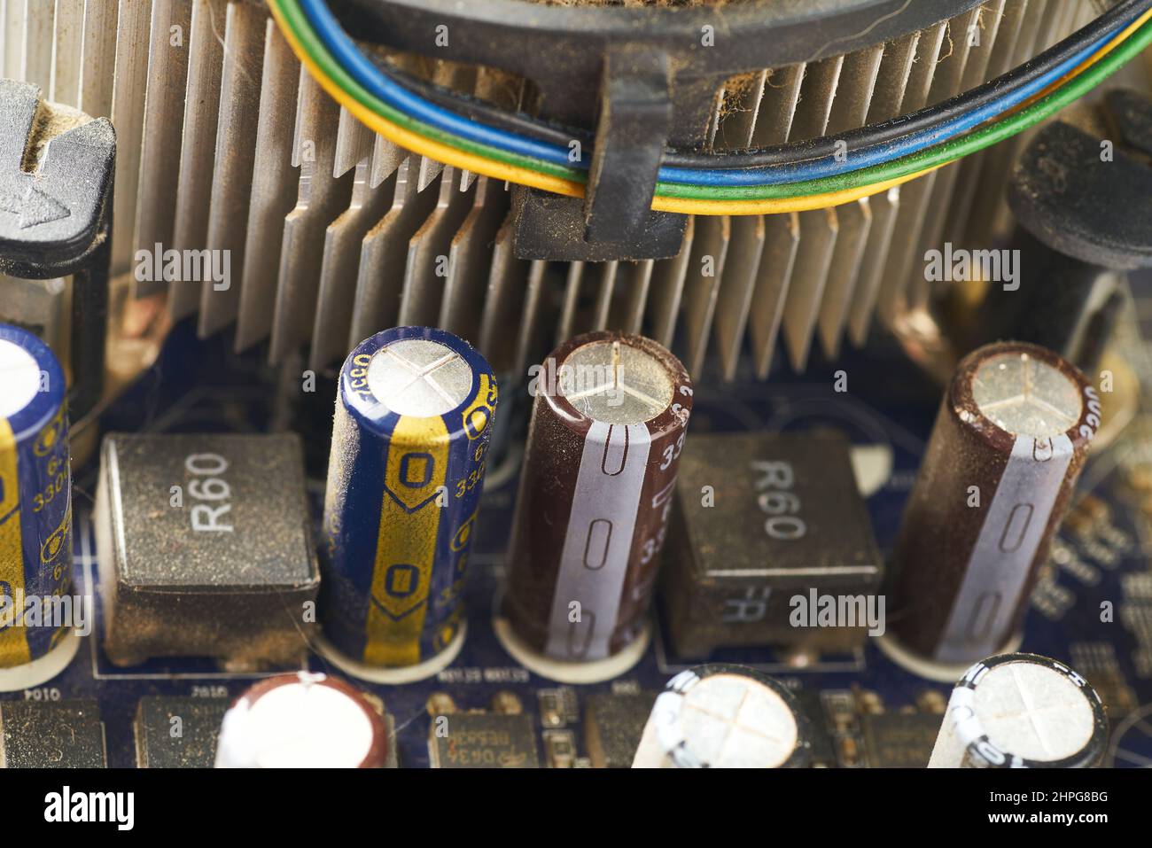 Old computer system unit with spider web and dust inside. Stock Photo