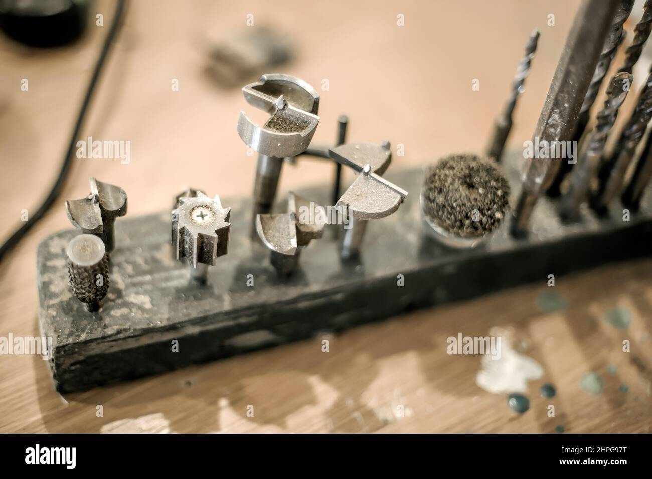 Close up of tools drill bit on wooden work table Stock Photo