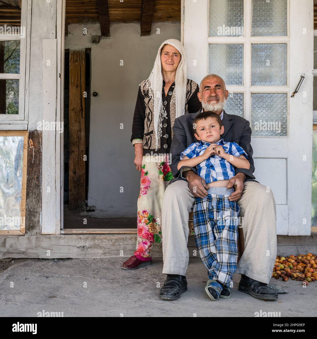 August 26, 2016, Margib village, Tajikistan: A local family by their house in a small village in Yaghnob region of Tajikistan Stock Photo