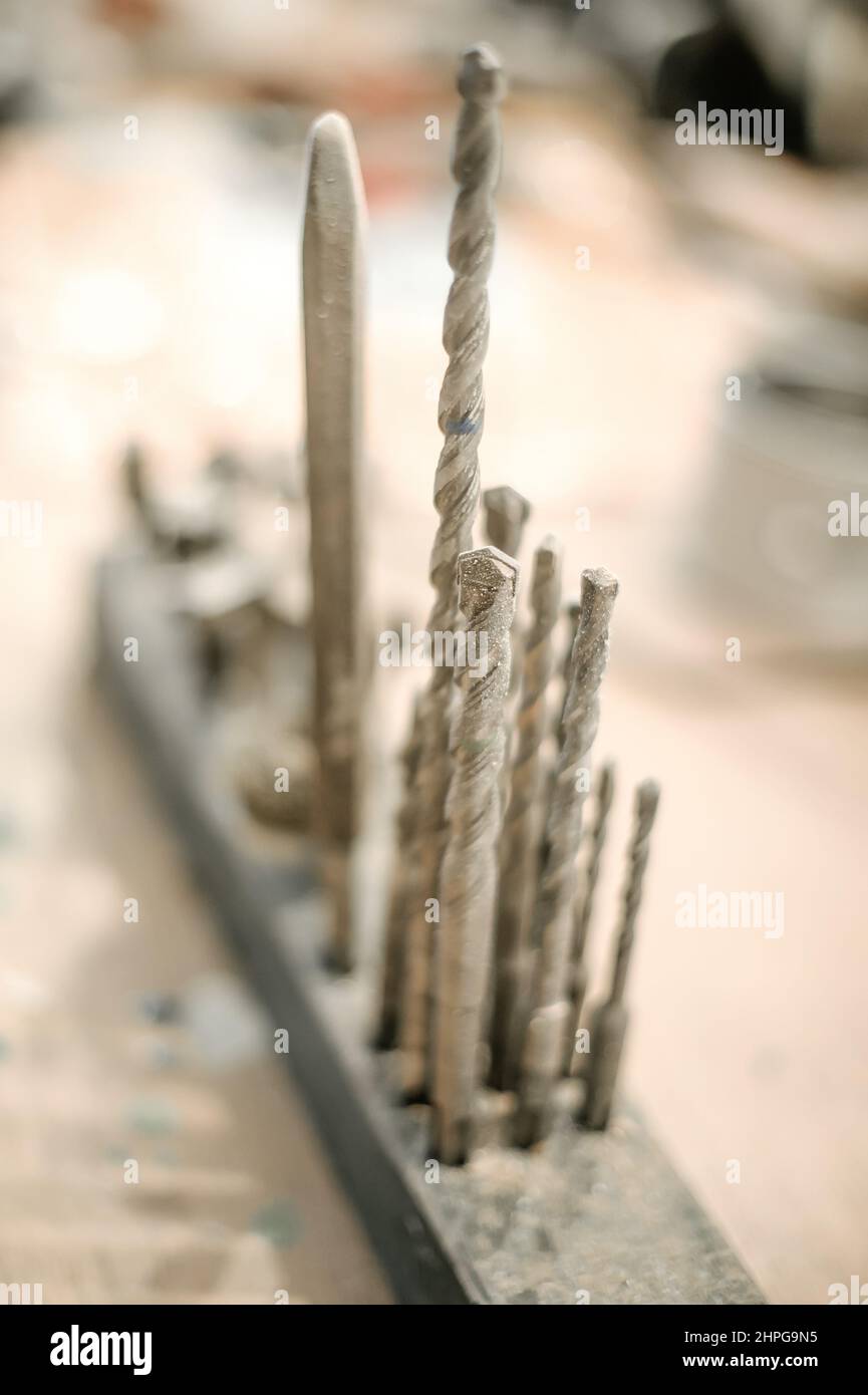 Close up of tools drill bit on wooden work table Stock Photo