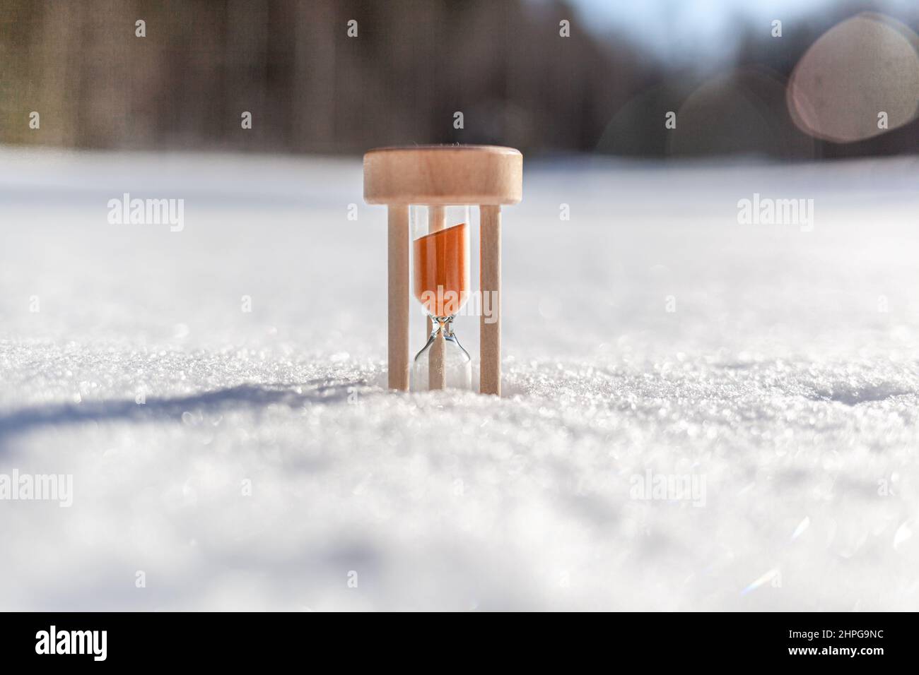 Hourglass in the snow. Spring is coming. melting snow Stock Photo - Alamy