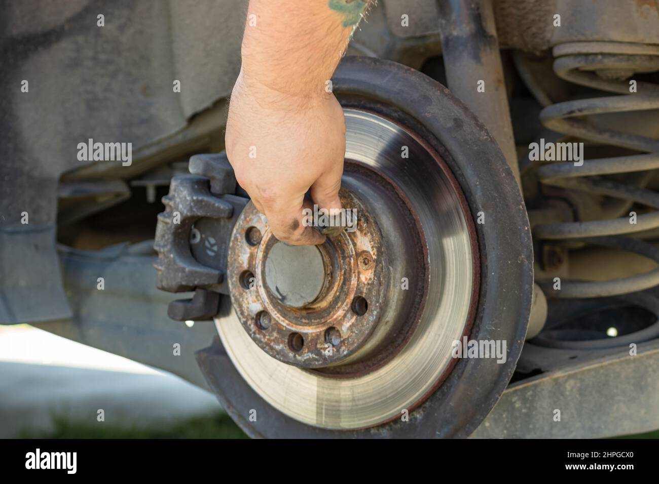 Automotive mechanic checking brake system. Vehicle maintenance in the ...