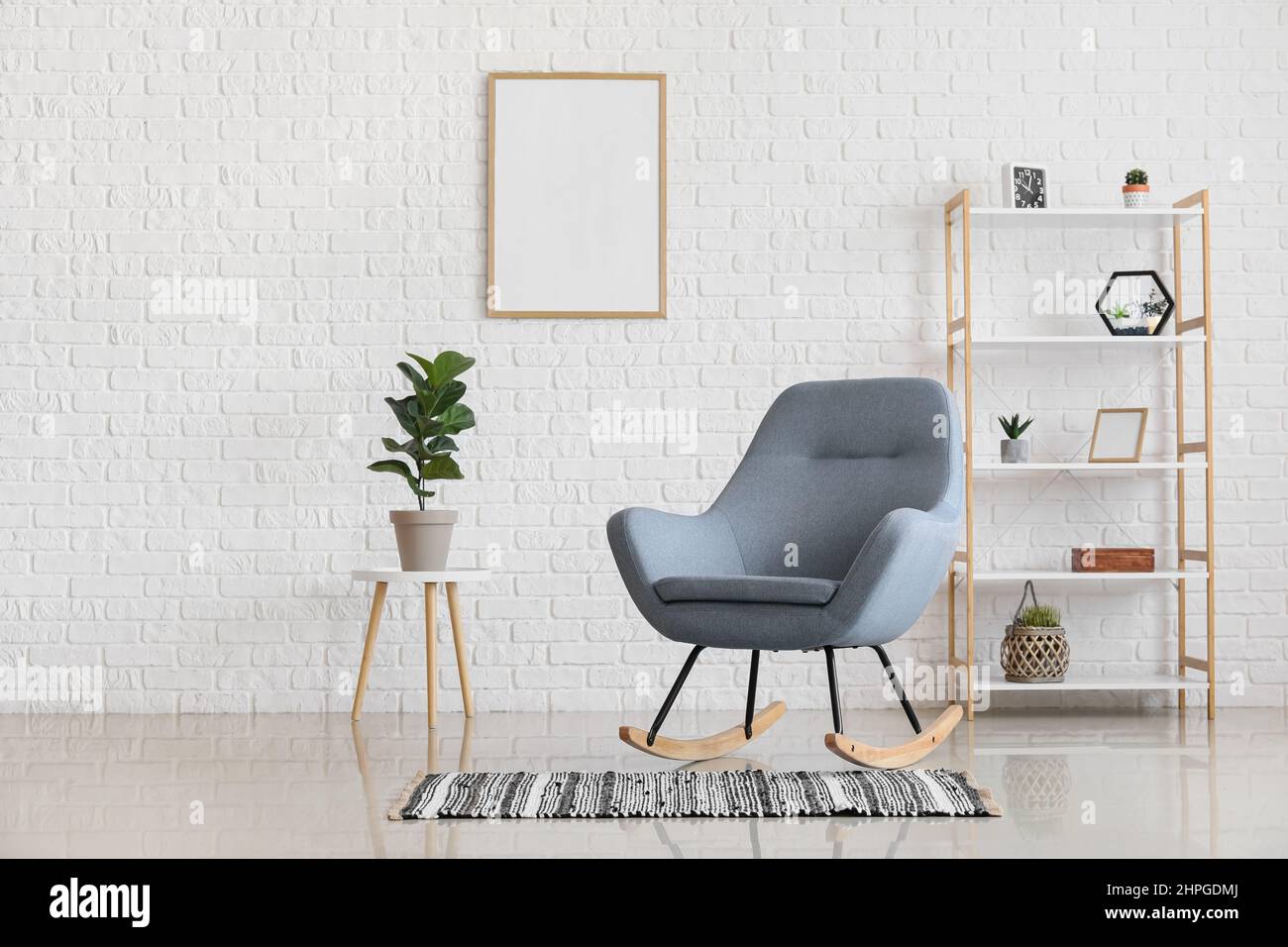Rocking chair, houseplant and rack in modern stylish interior of living ...