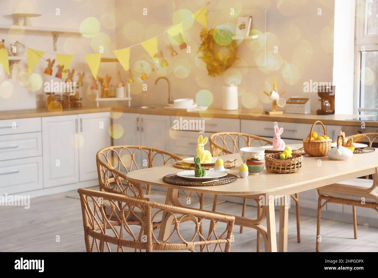 Festive table setting for Easter dinner in kitchen Stock Photo