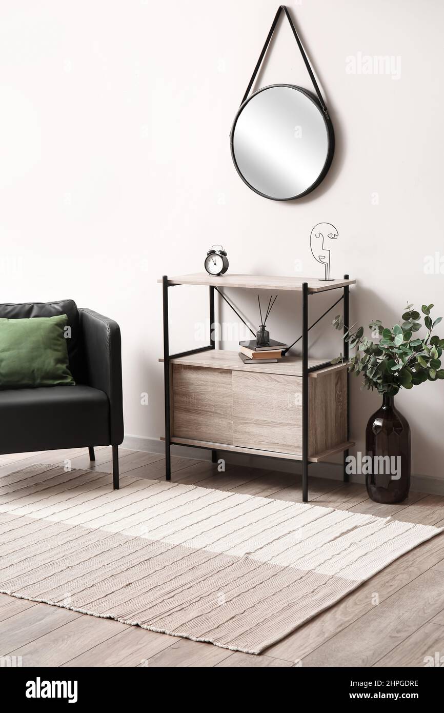 Stylish interior of light room with standing desk, mirror and carpet Stock Photo Alamy