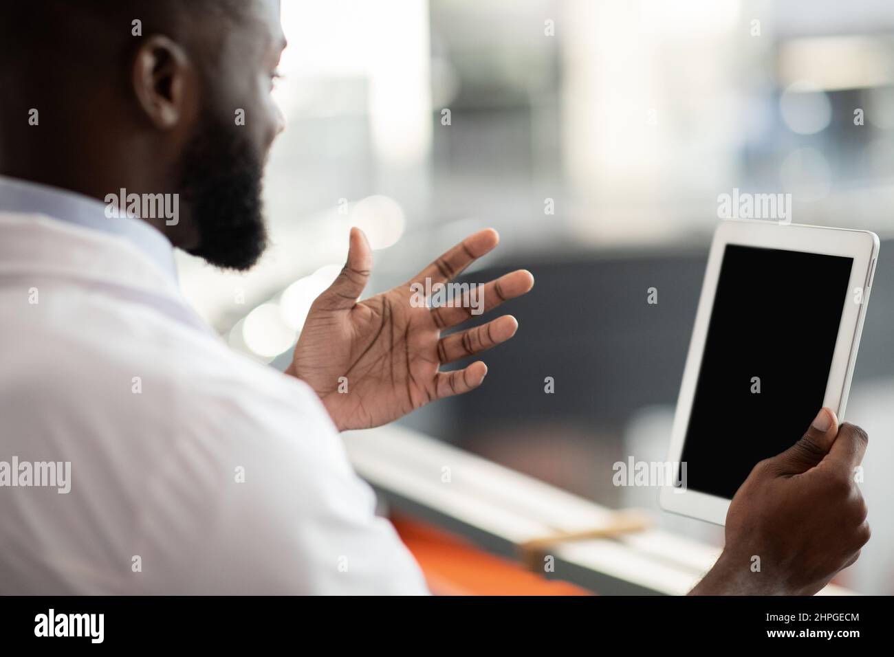 Black scientist using digital tablet with empty screen, mockup Stock Photo