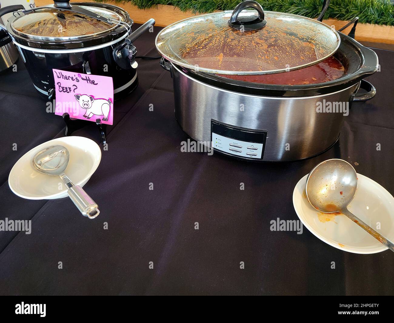 Crockpots on a tablecloth in a chili cook-off contest Stock Photo