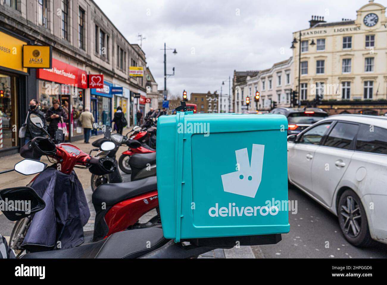 WIMBLEDON LONDON, UK. 21 February, 2022. Deliveroo riders stand idle in