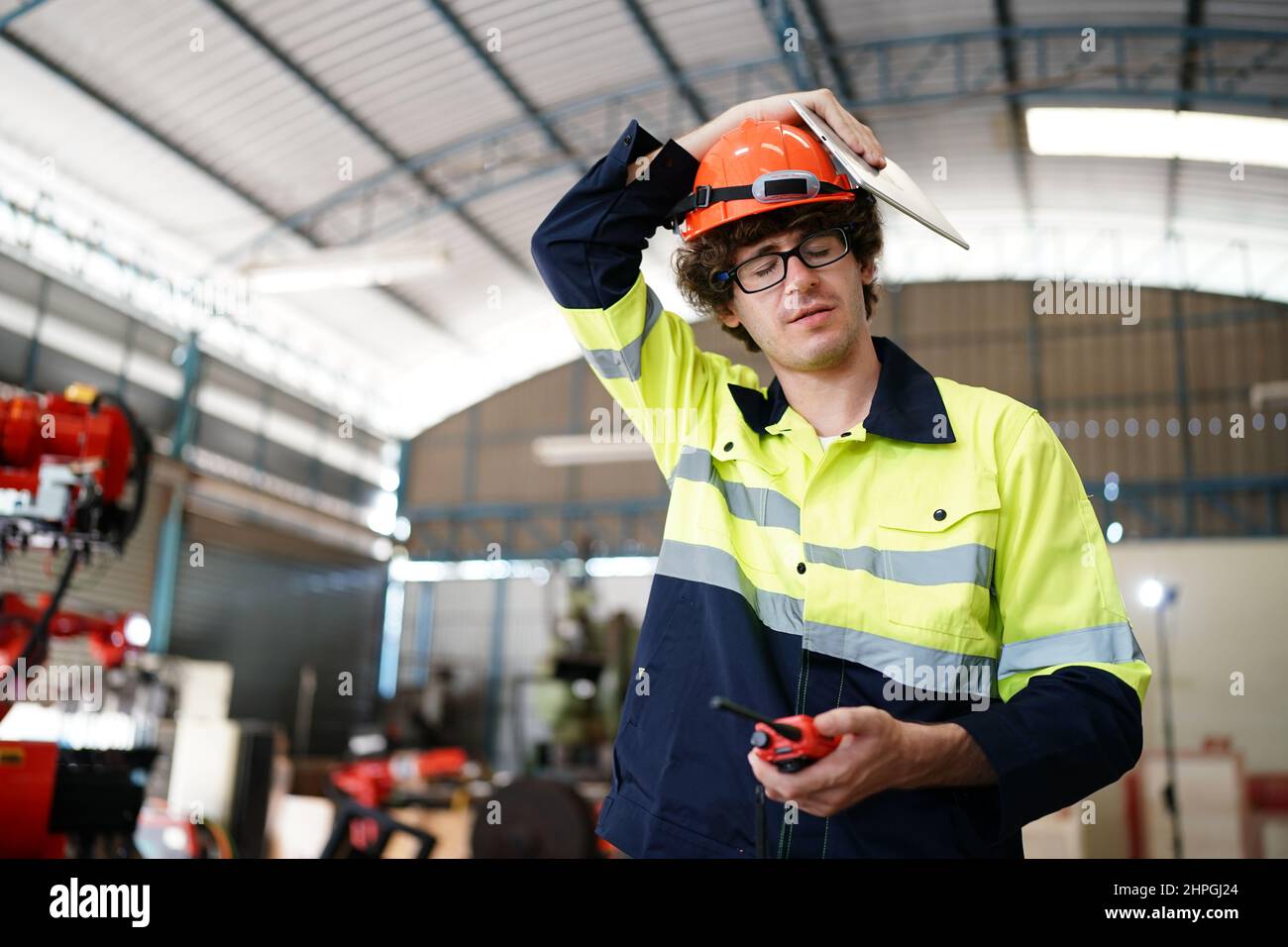 engineer checking control panel and teaching new Automatics robot arm and operating control machine in factory. Stock Photo