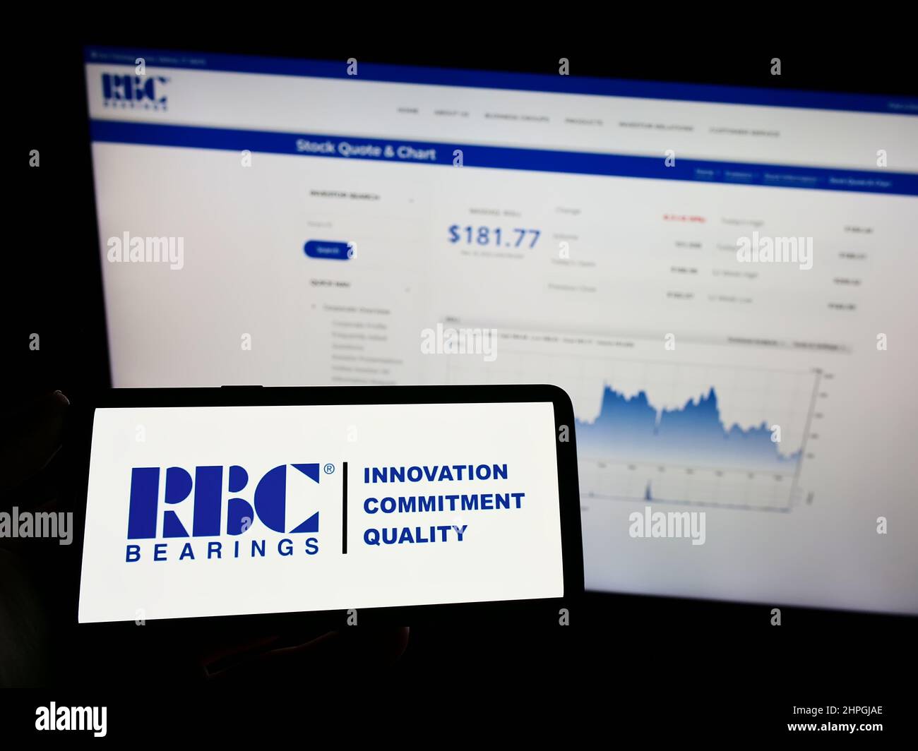 Person holding mobile phone with logo of American manufacturing company