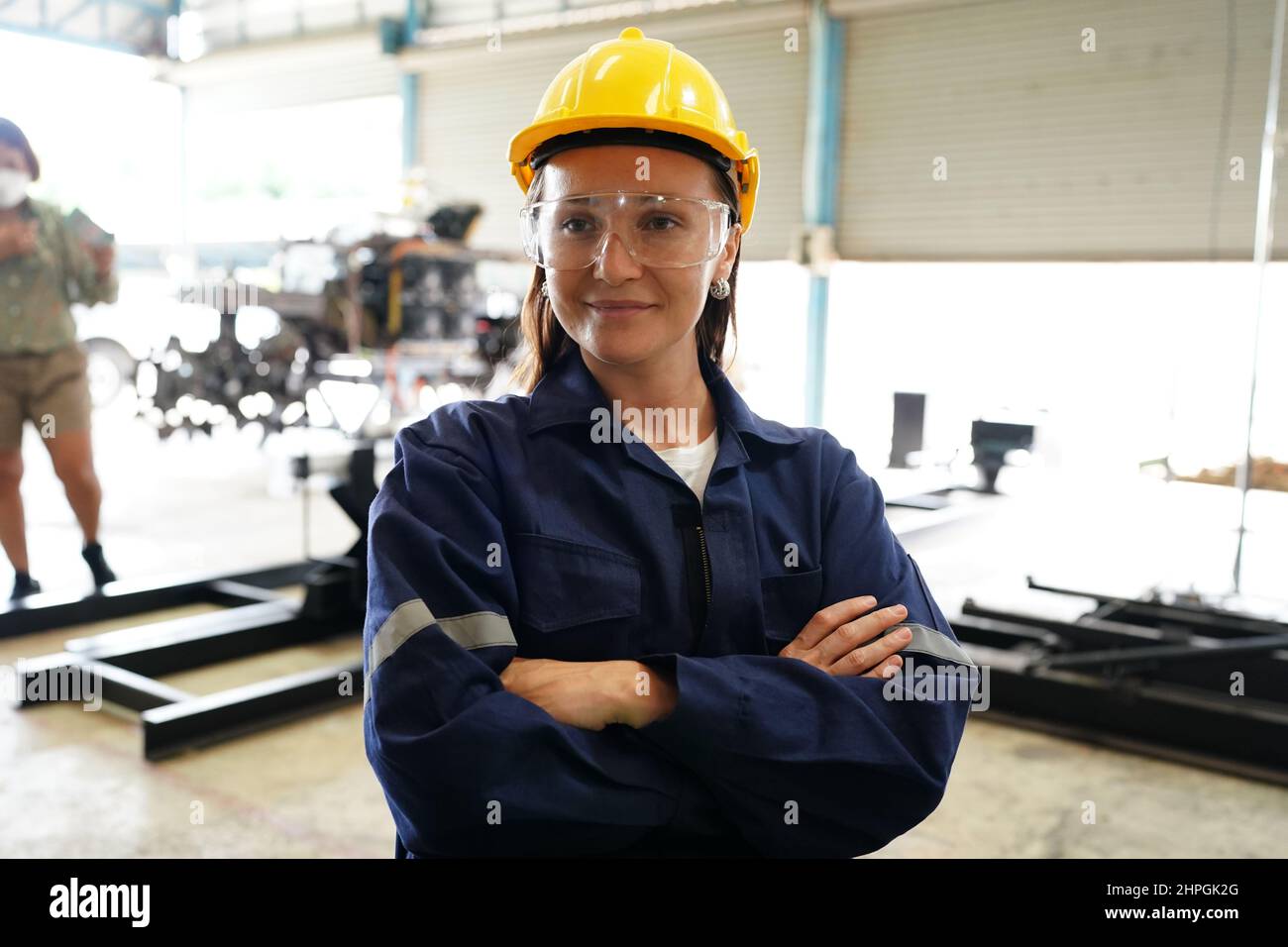 Female industrial worker working with manufacturing equipment in a factory Stock Photo