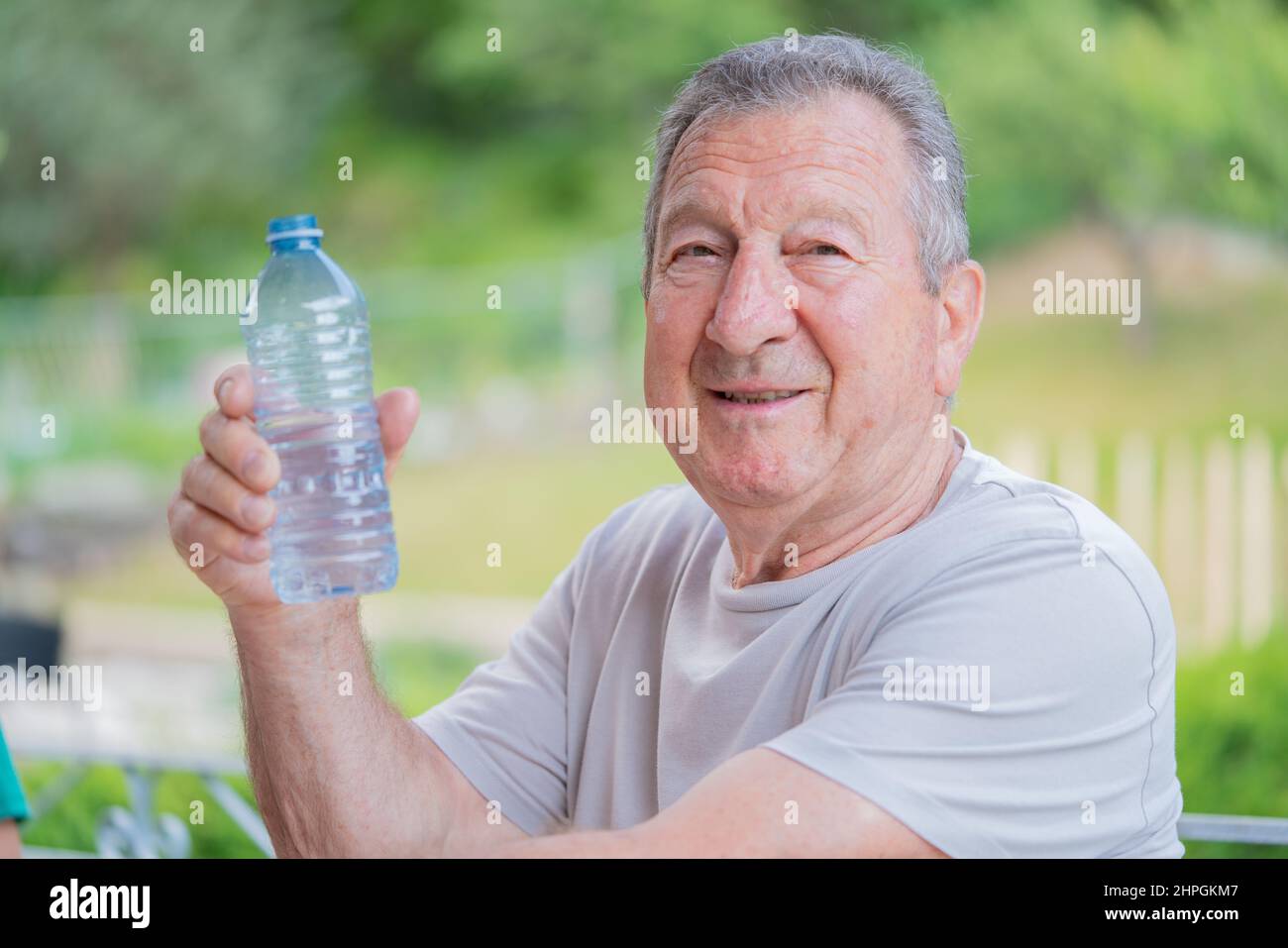 Healthy and happy, retired elderly man drinking water and staying hydrated in Toronto, Ontario Canada Stock Photo