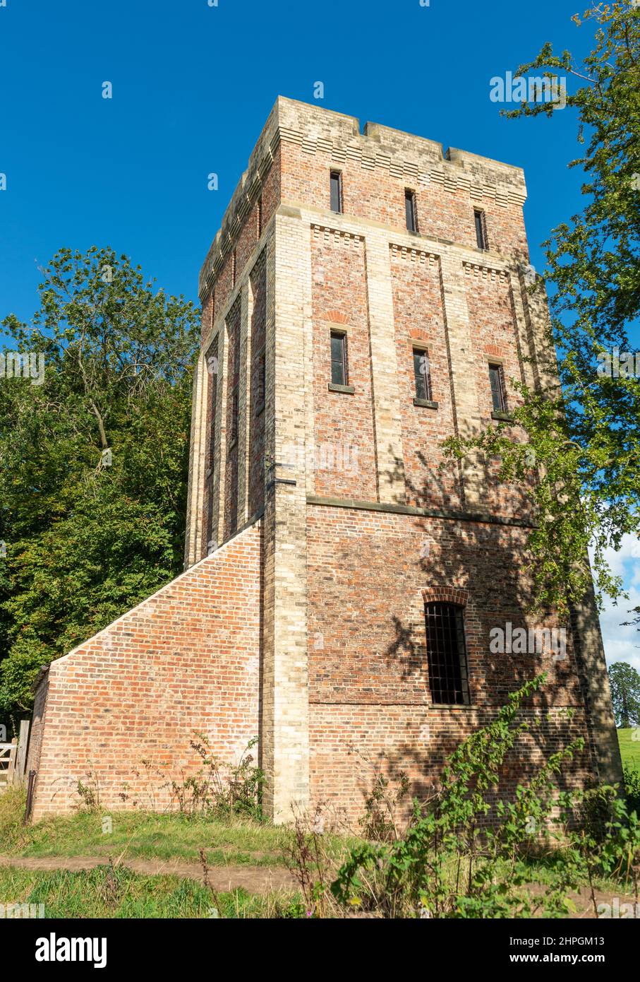 the castellated brick built water tower and pump house next to the River Ouse at Beningbrough Park Stock Photo