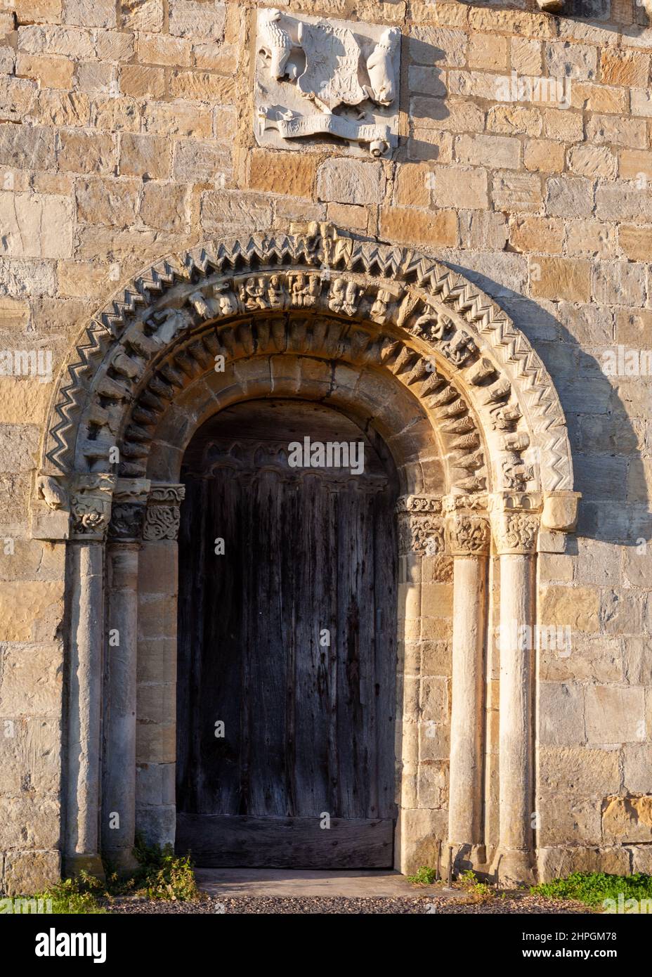 The ornately carved Norman entrance doorway of Healaugh church in North Yorkshire Stock Photo