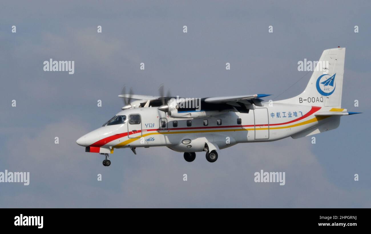 Moscow Russia AUGUST, 26, 2015 Harbin Y-12 Chinese high wing twin-engine turboprop utility aircraft in flight in the blue sky. Harbin Y-12 is used by many military, civil and government operators. Stock Photo
