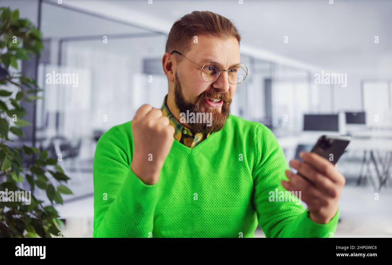 Man with smartphone at office Stock Photo