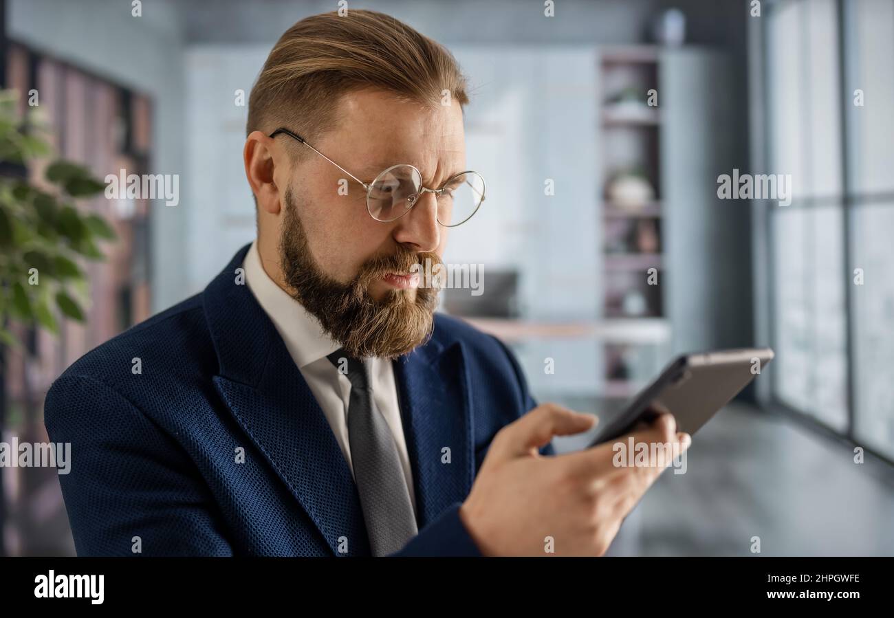 Businessman at office with smartphone Stock Photo
