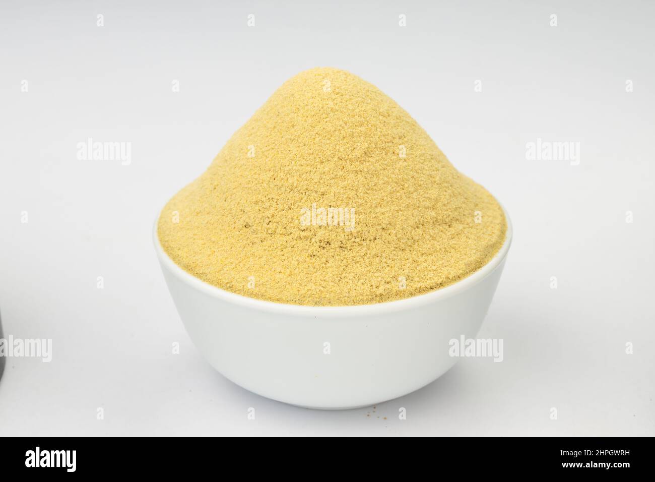 Fenugreek powder, Indian spice;arranged in a white bowl with white