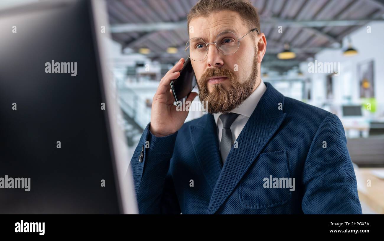 Man talking on mobile at office Stock Photo