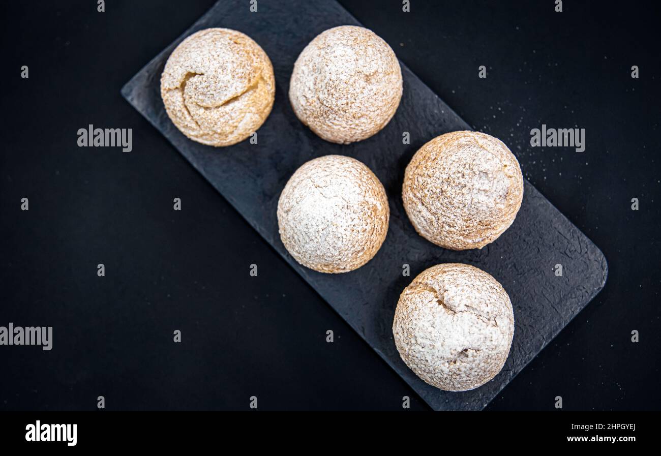 Appetizing Shu cakes on a black background. Stock Photo