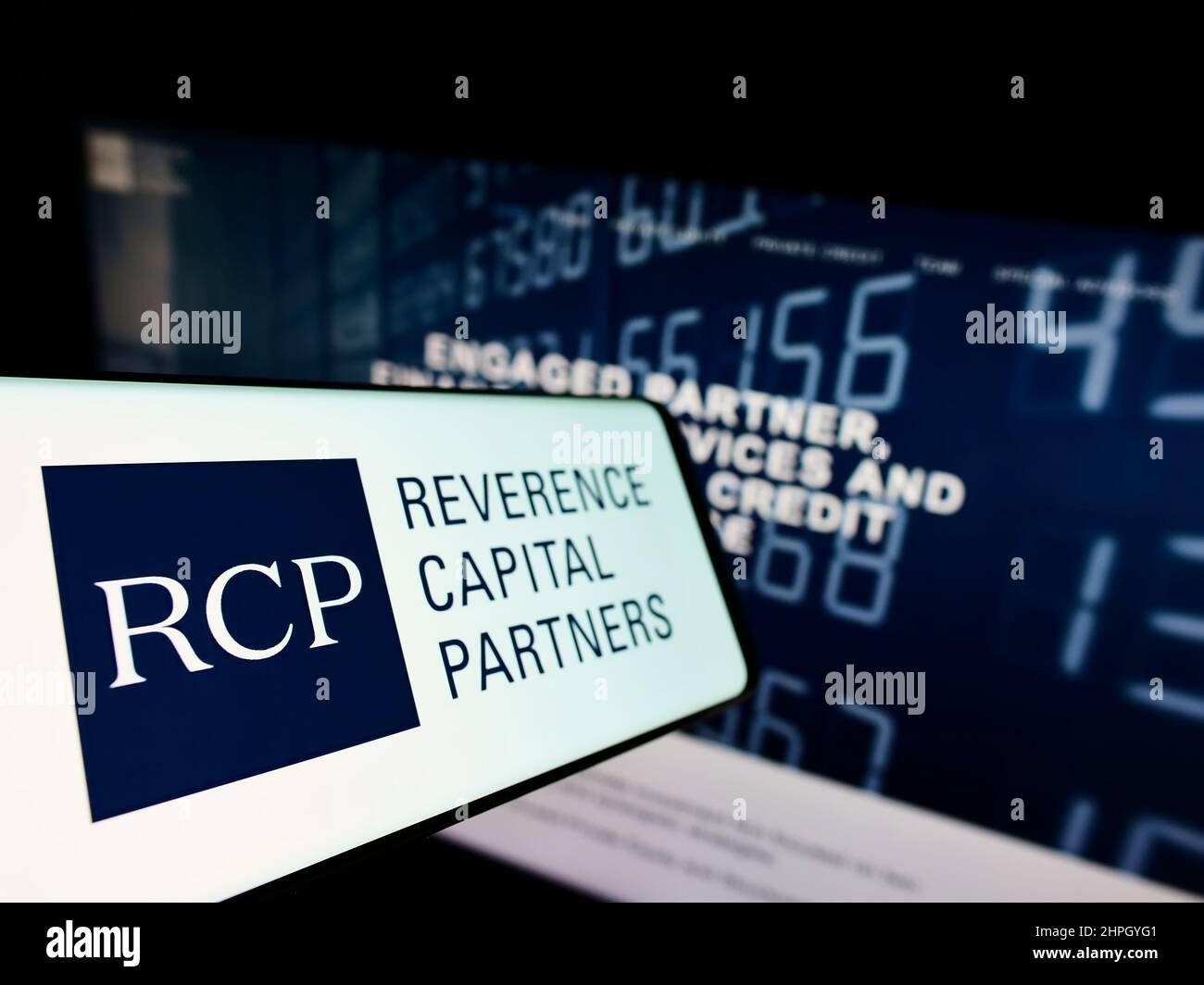 Mobile phone with logo of American company Reverence Capital Partners L.P. (RCP) on screen in front of website. Focus on left of phone display. Stock Photo