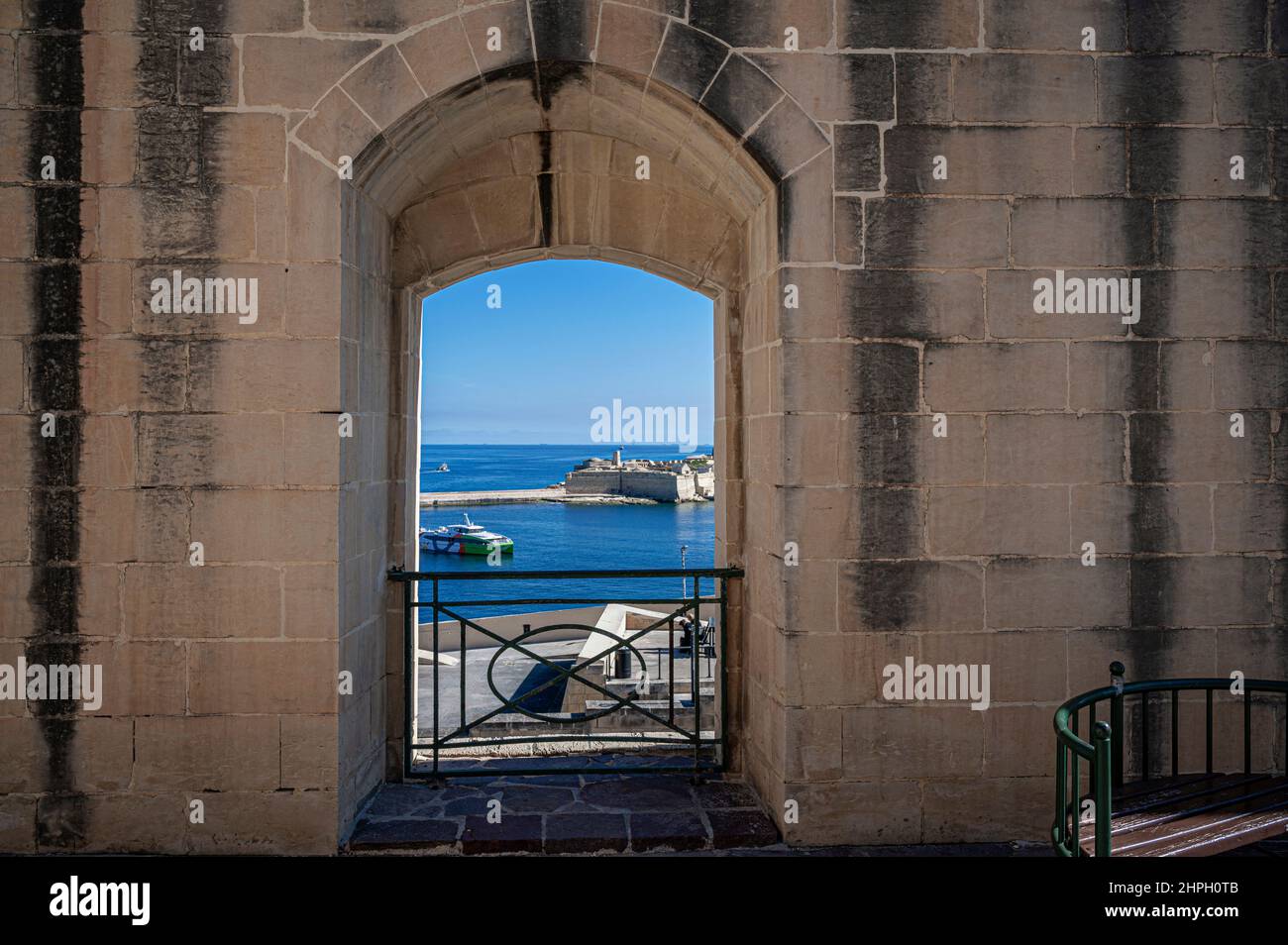 View of Mediterranean sea from window in city wall in Valletta, Malta. View from lower barrakka gardens. Stock Photo