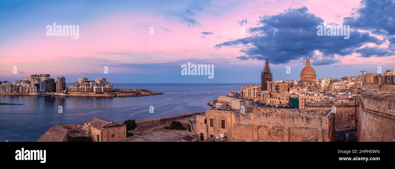 Panoramic view of sunset over Valletta old town and harbor, Valletta, Malta. Stock Photo