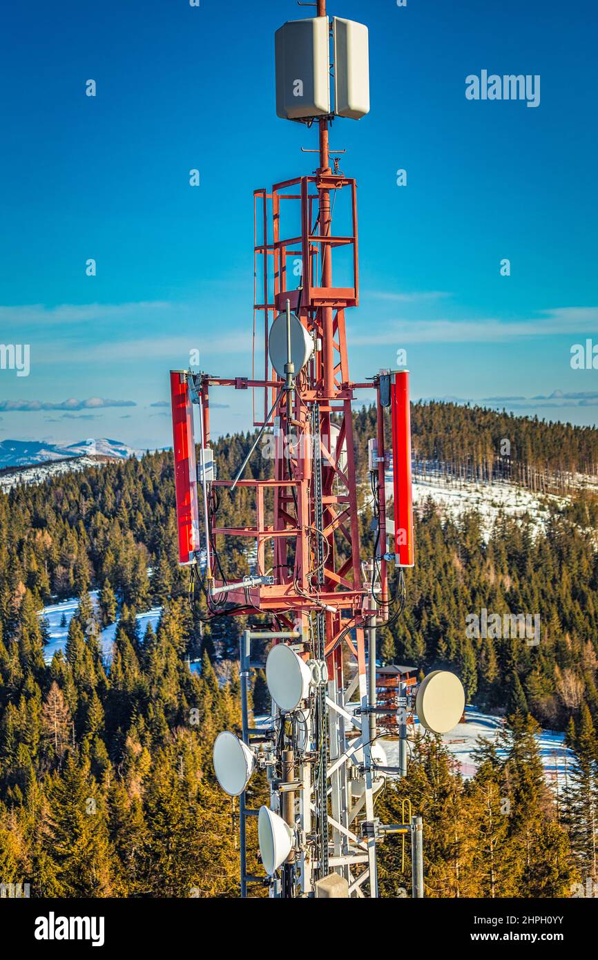 Telecommunication tower with antennas in mountain landscape. Stock Photo