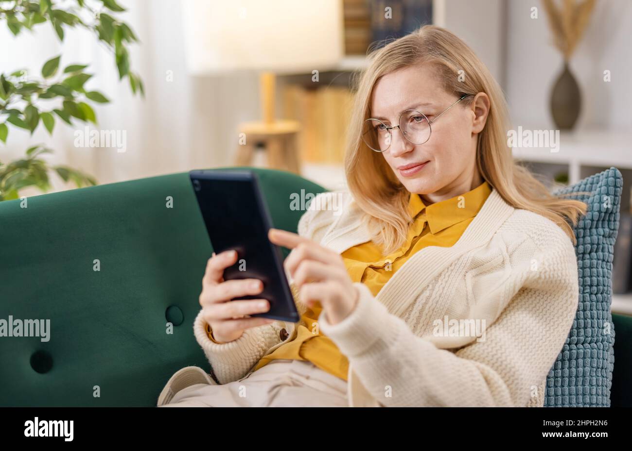 Mature woman lying on couch hi-res stock photography and images - Alamy