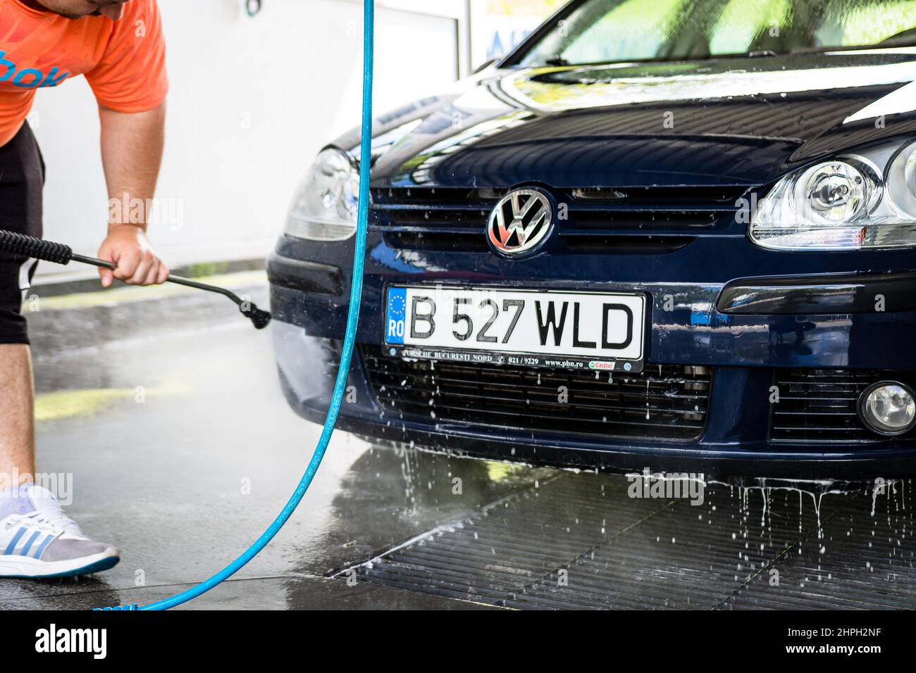 Washing and cleaning car in self service car wash station. Car washing
