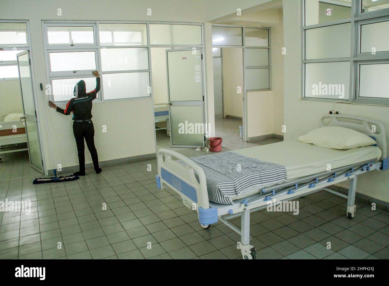 An officer seen cleaning the isolation room during a simulation of ...