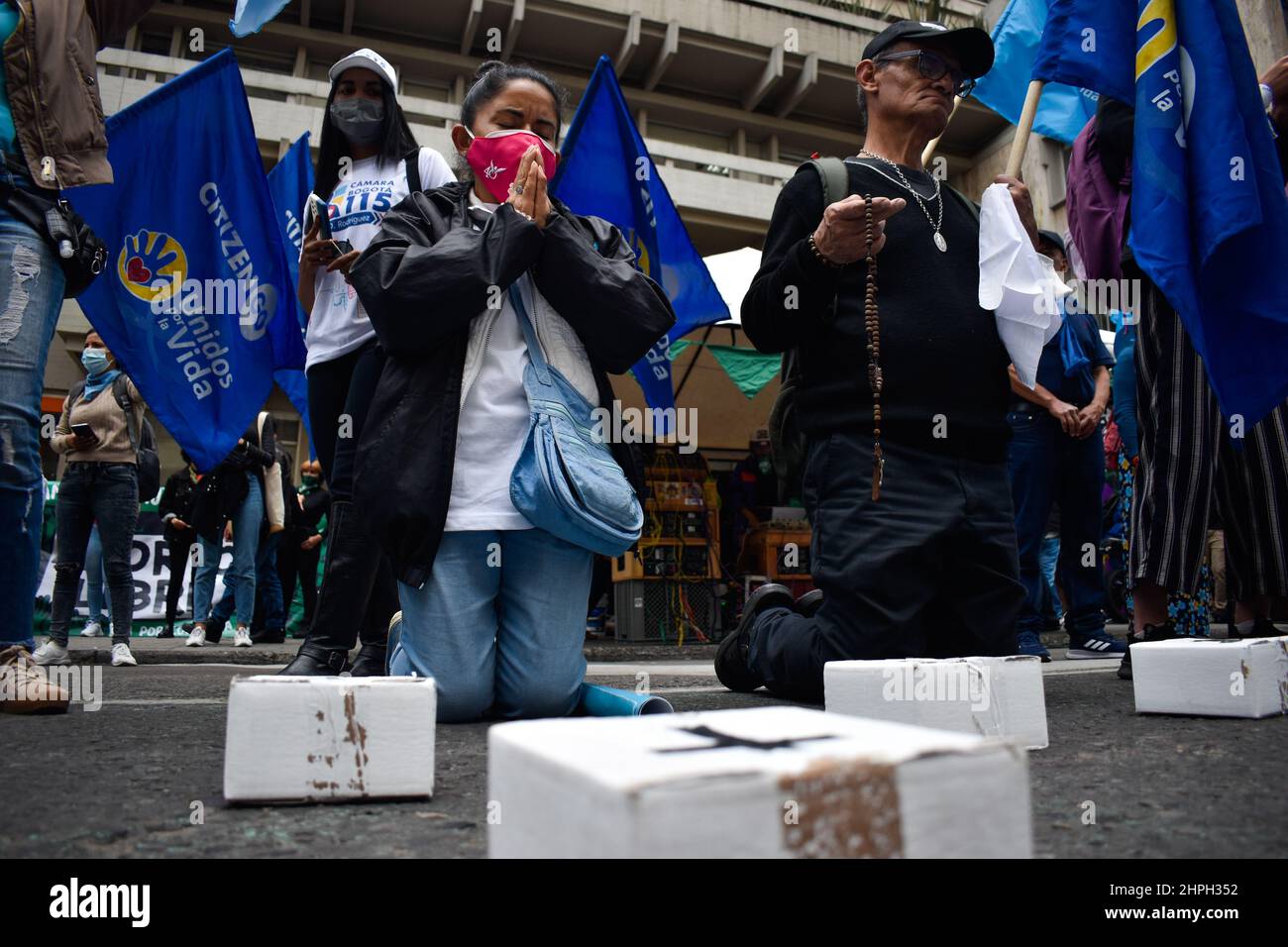 Anti-abortion movements protests with religous symbols as both Pro-Choice and anti-abortion movements protest outside in support and against the decriminalization of abortions from the penal code, outside the Constitutional Court in Bogota, Colombia on February 21, 2022. Stock Photo