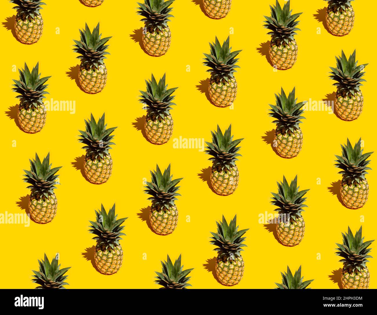 Pineapple pattern on yellow background Stock Photo