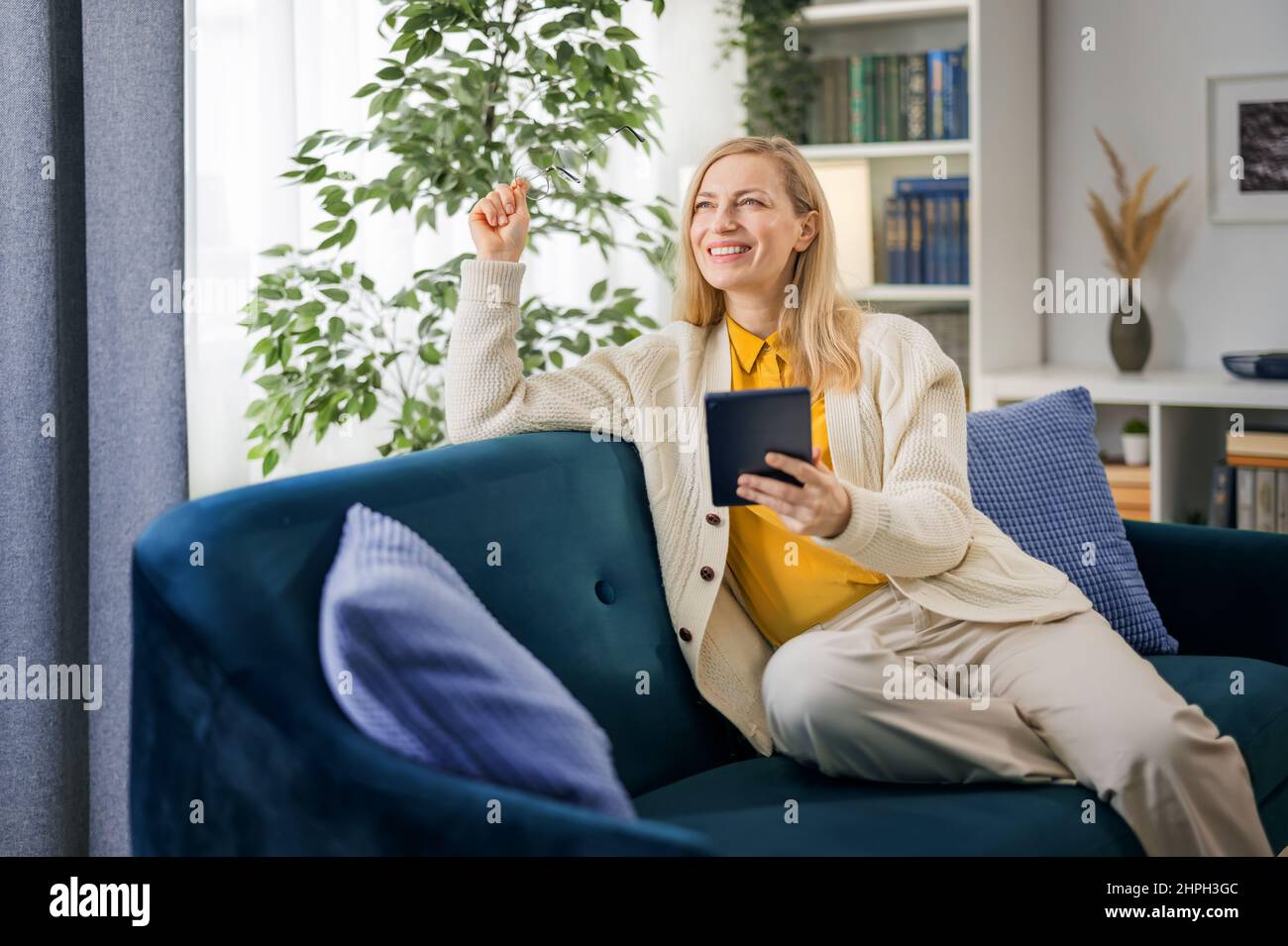 Mature woman home happy couch hi-res stock photography and images - Alamy
