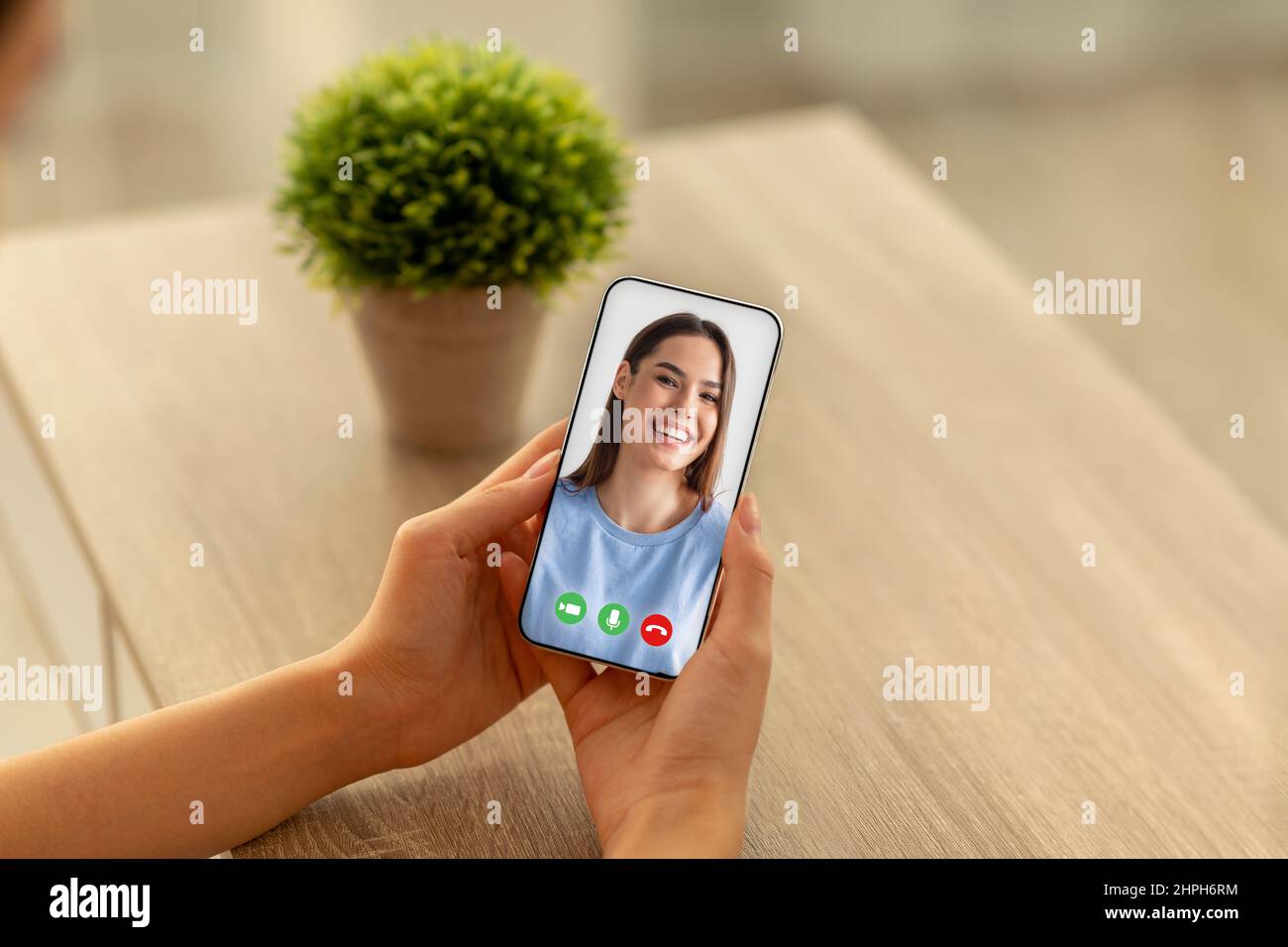 Distance Communication. Female with smartphone making video call to her ...