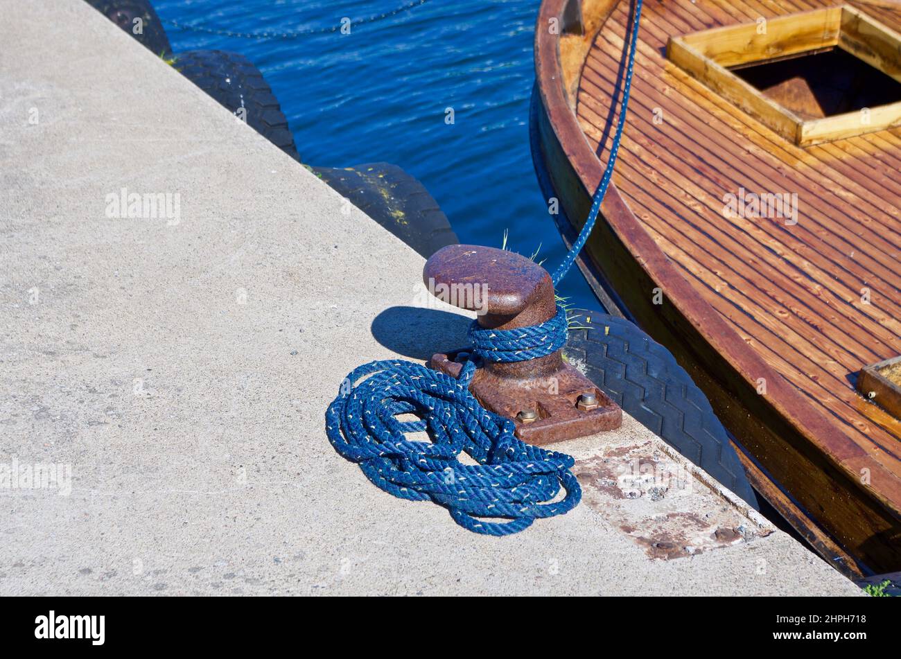 Wooden sailboat that is moored at a quay. Stock Photo