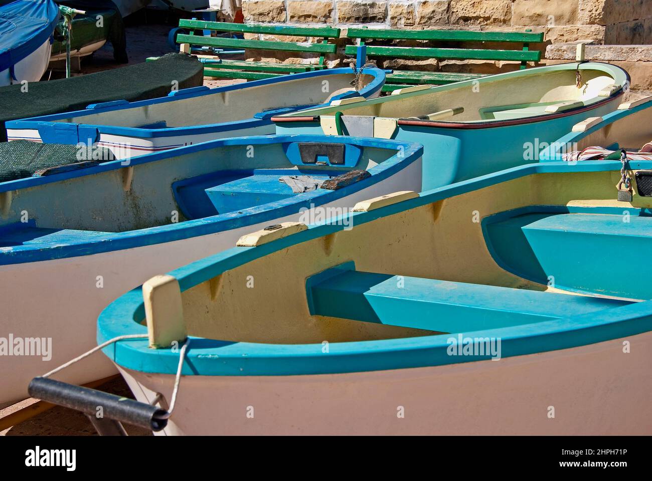 Small rowing boats for hire in a harbor on the island Malta. Stock Photo