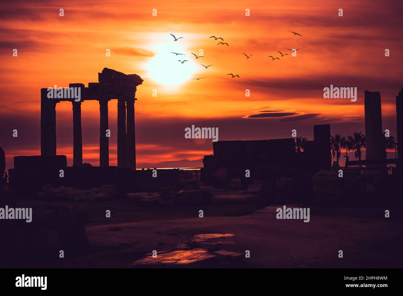Silhouette of Apollon Temple in Side antique city, temple of Apollon ancient ruins at sunset. Greek ancient historical antique Side Antalya Turkey. Stock Photo