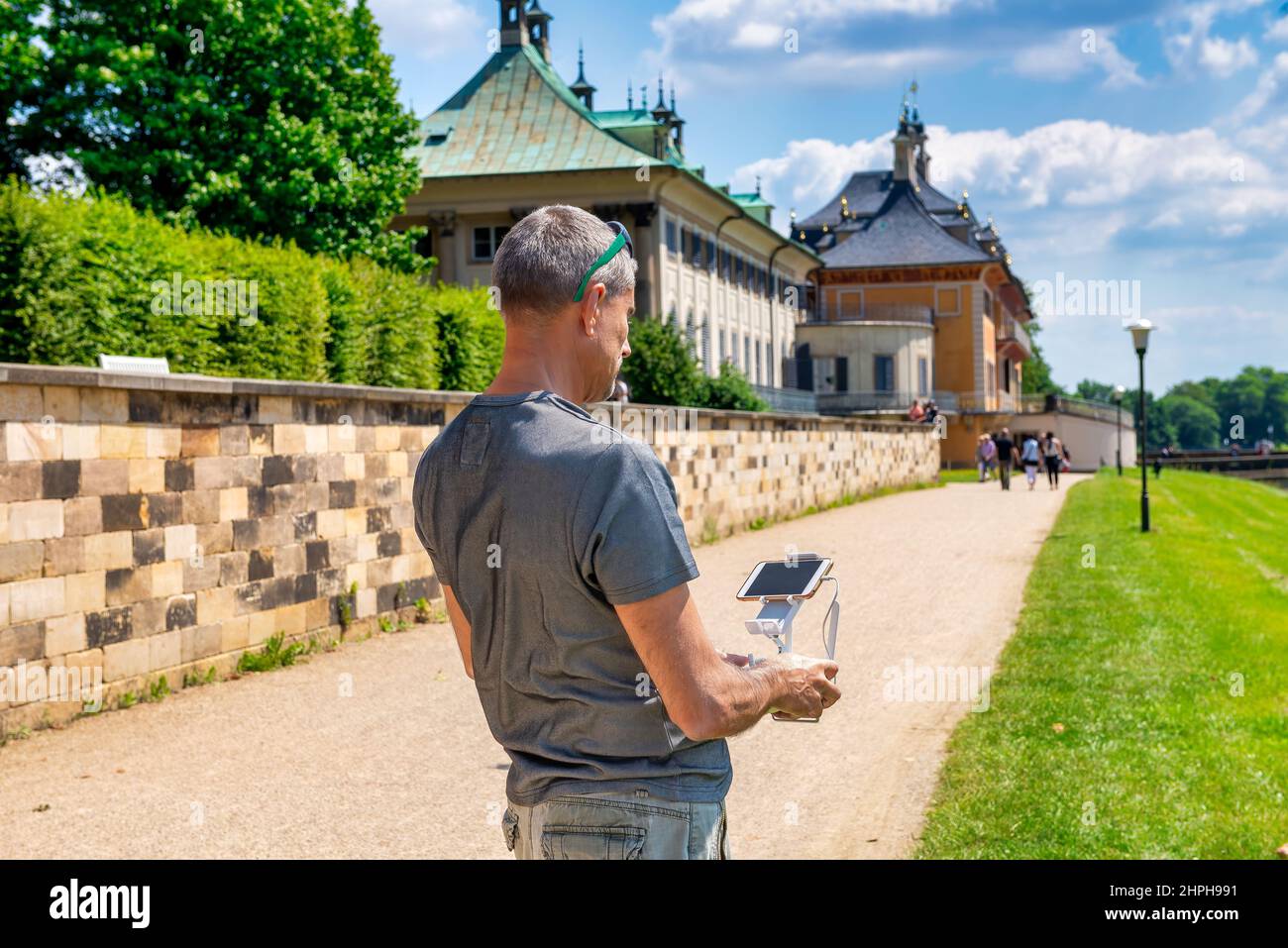 Man outdoor using the remote to control his drone Stock Photo
