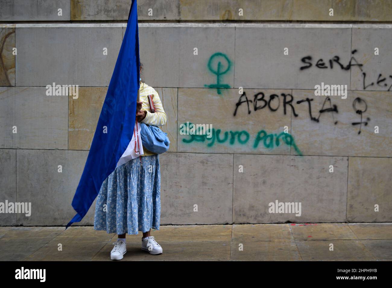 Anti-abortion movements protests with religous symbols as both Pro-Choice and anti-abortion movements protest outside in support and against the decriminalization of abortions from the penal code, outside the Constitutional Court in Bogota, Colombia on February 21, 2022. Stock Photo
