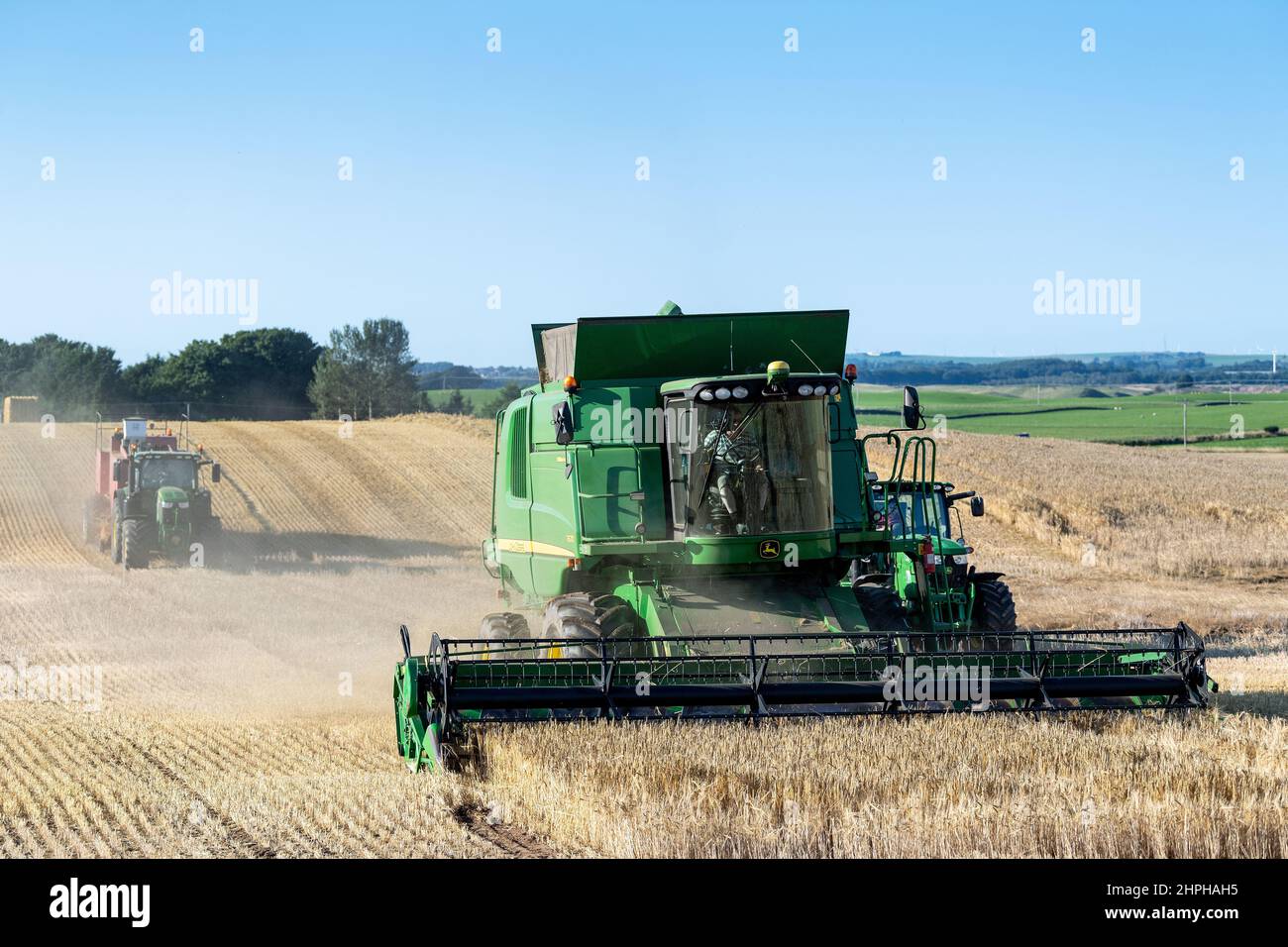 Combining wheat crop with a John Deere T670 combine near Lanark, Scotland, UK. Stock Photo