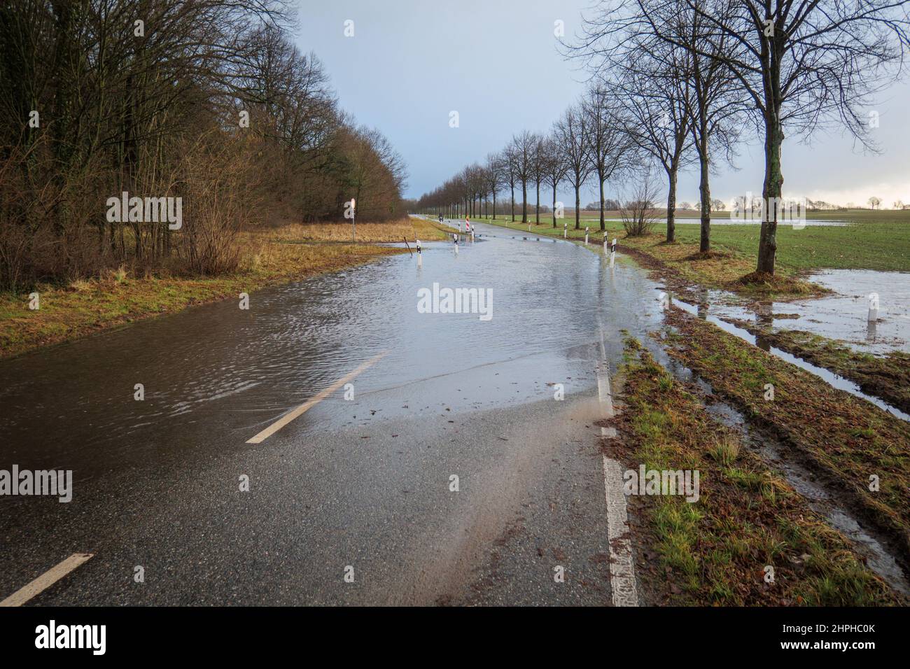a country road is flooded after heavy rainfall Stock Photo - Alamy