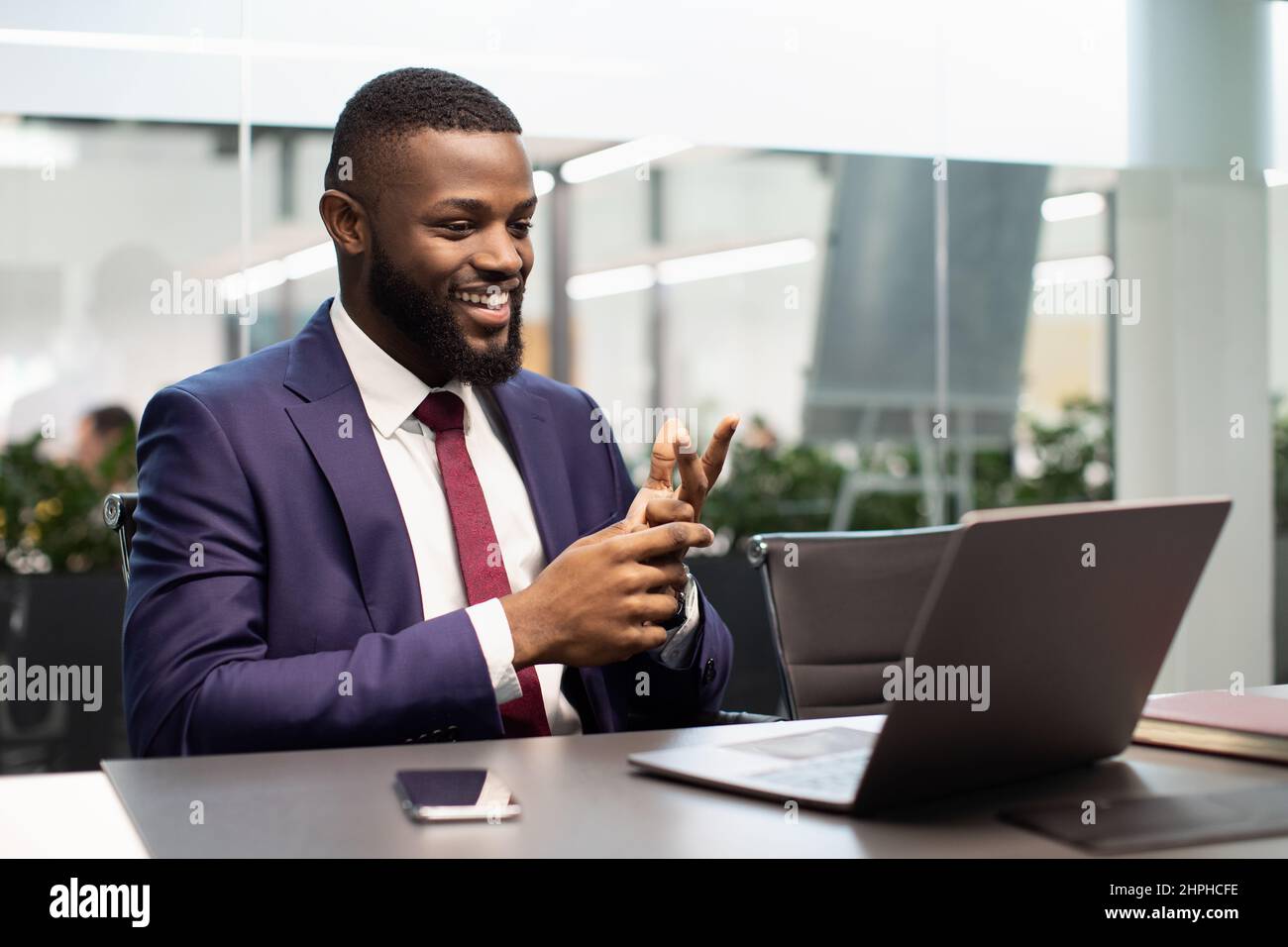 Handsome black businessman having video chat, using laptop Stock Photo