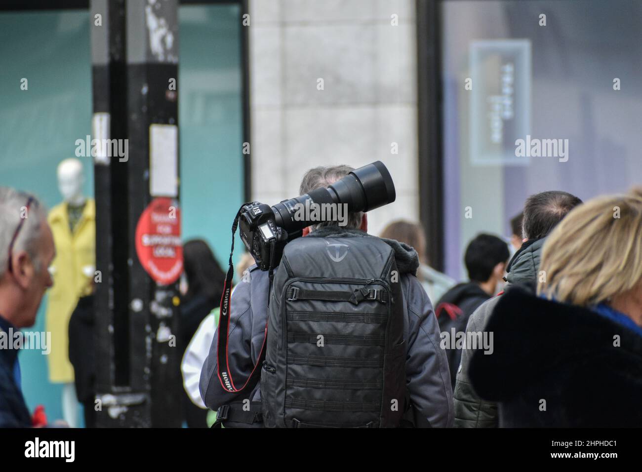 Photographer walking with a camera, Cork City. Ireland Stock Photo