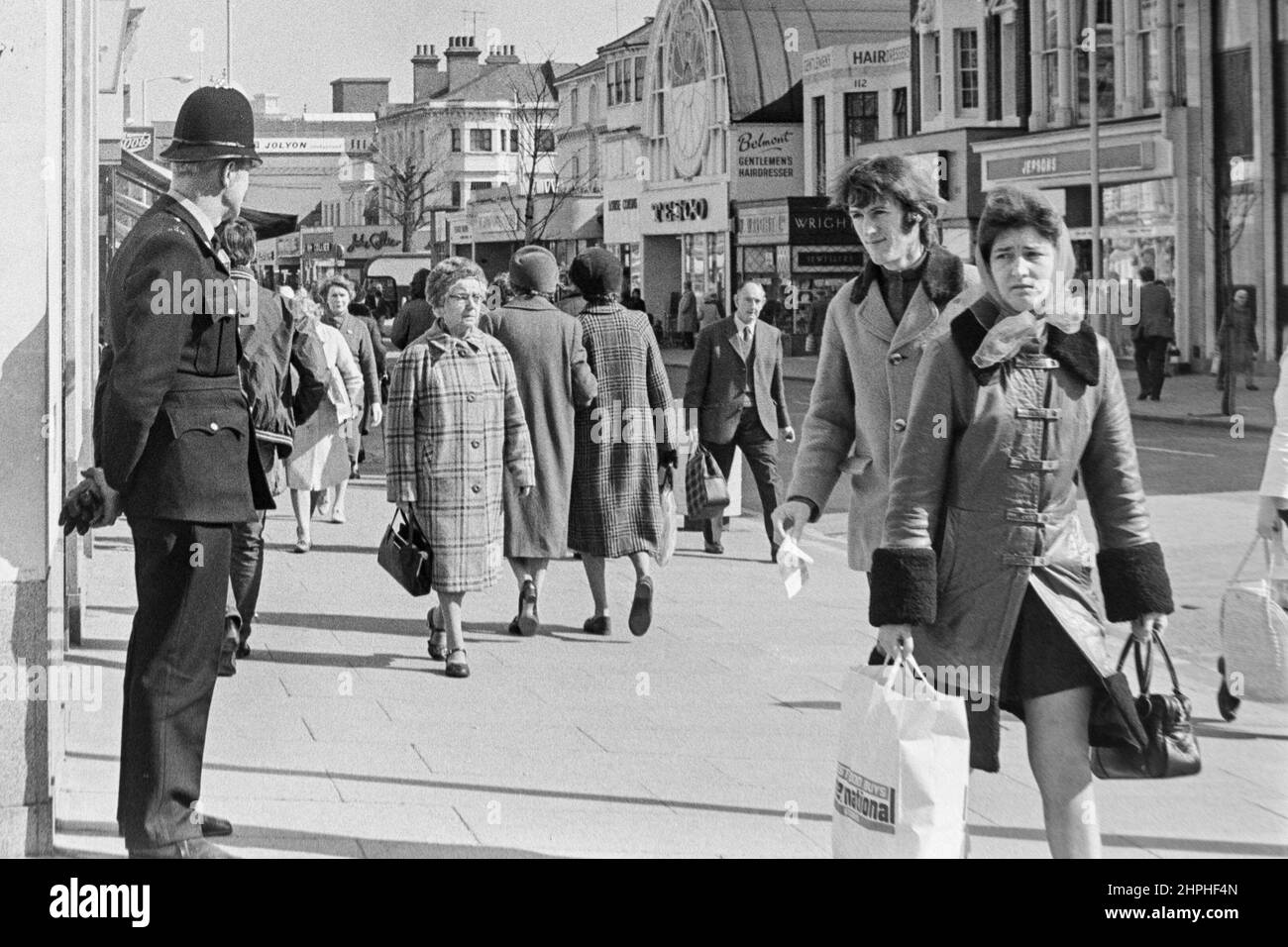 1970 photograph of a policeman on duty watching shoppers in Terminus Road, Eastbourne, E Sussex, England, UK. Stock Photo