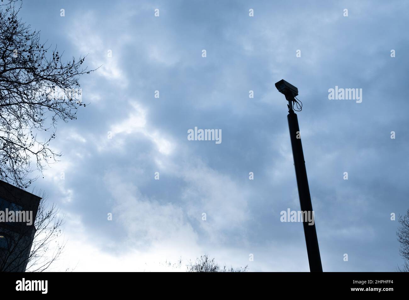 Aerial CCTV camera against a moody winter sky Stock Photo