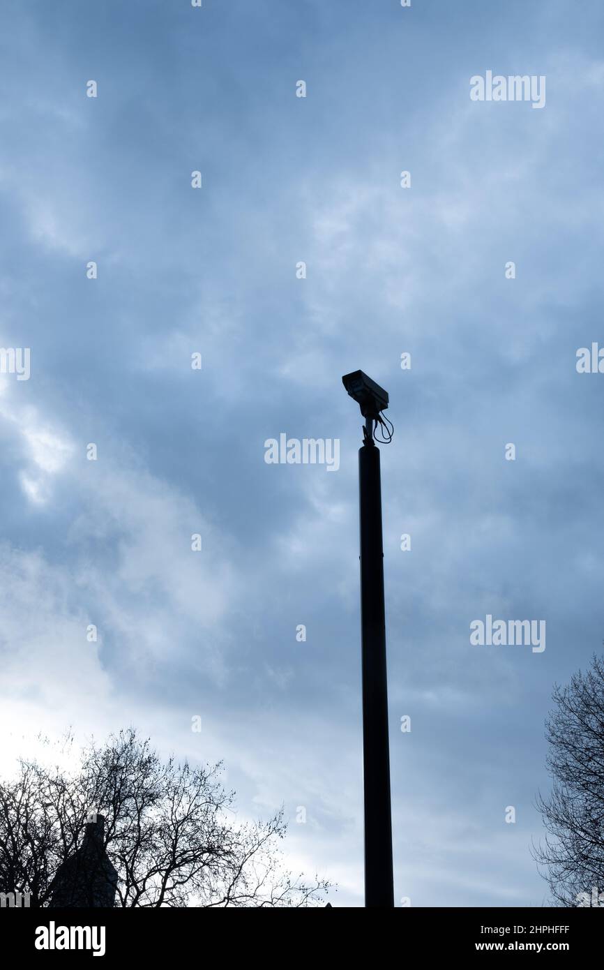 Aerial CCTV camera against a moody winter sky Stock Photo