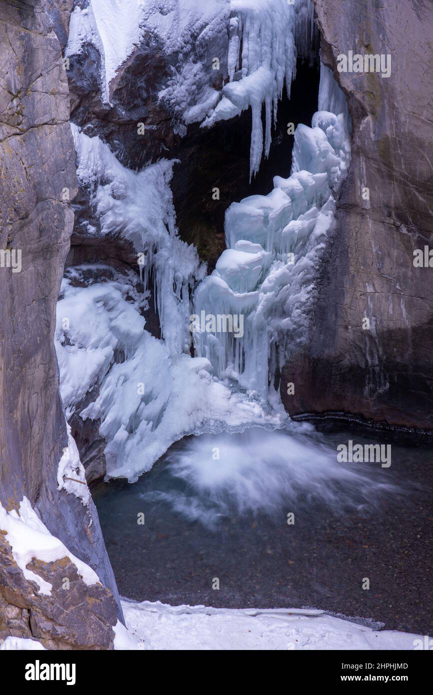 Water cascades out of the bottom of the frozen Box Canyon waterfall in