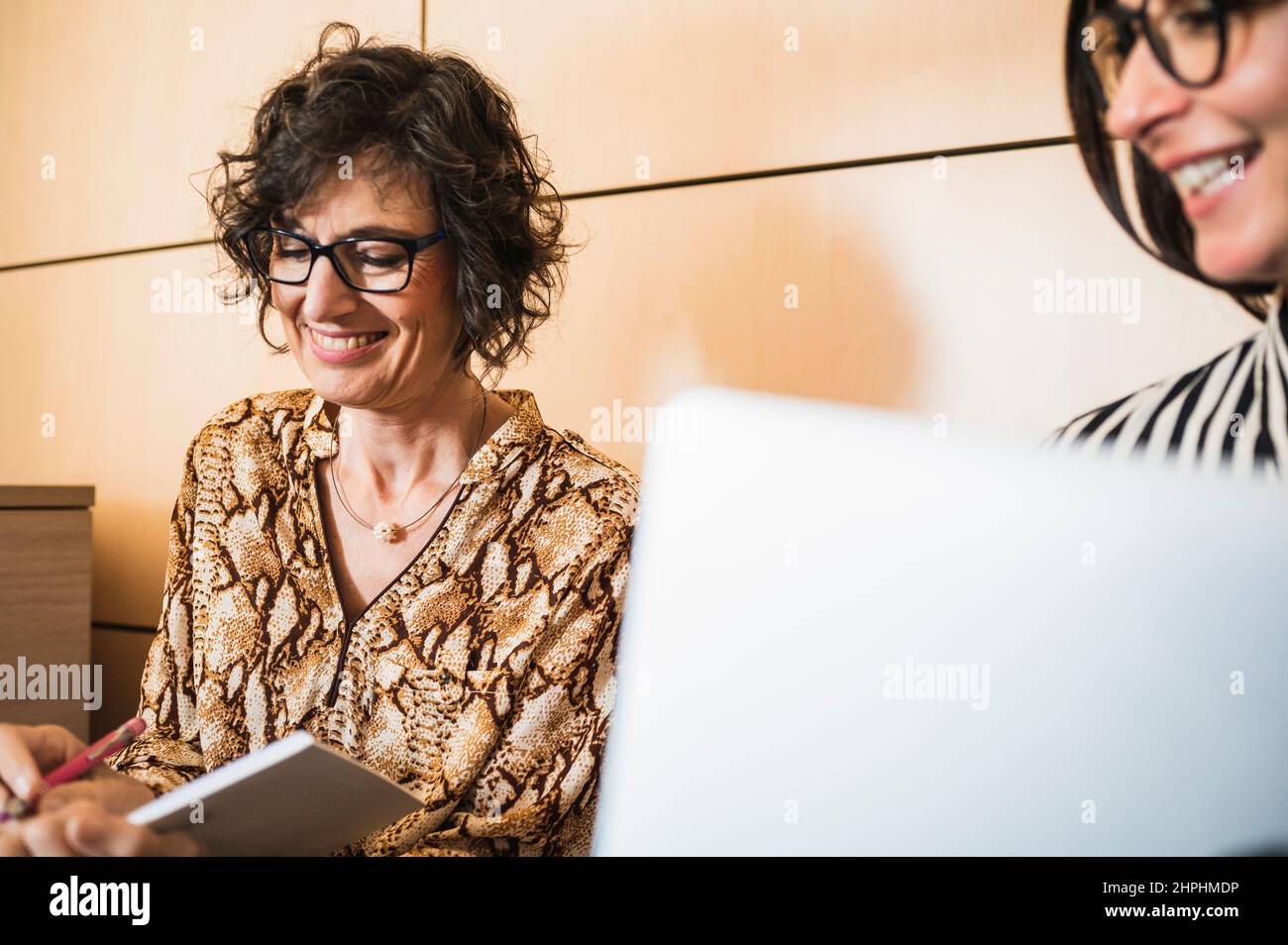 Side view of senior and middle age women working in an office. Stock Photo